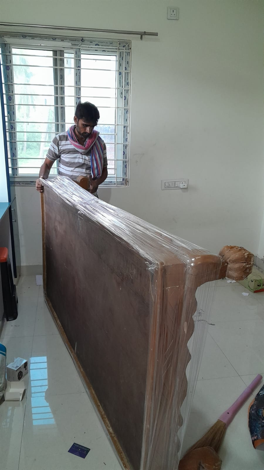 Professional packers wrapping furniture for shifting